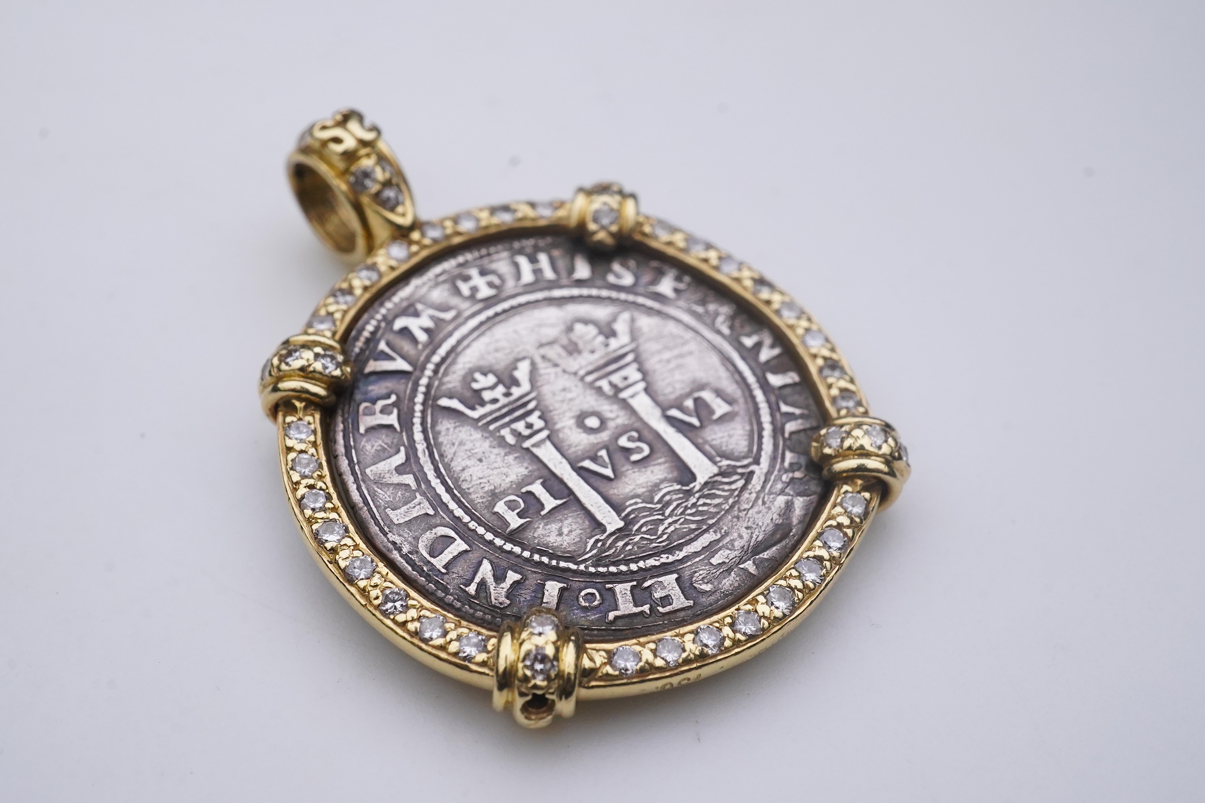 An unusual diamond and 16th century Mexican coin pendant